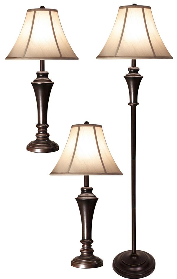 A set of two aged bronze steel table lamps and one aged bronze steel club floor lamp with beige fabr